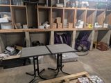 two tables that are sitting in the middle of a room