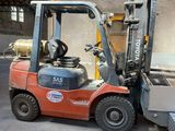 a fork lift truck parked in front of a building