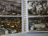 an open book with a picture of a city in it