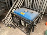 a blue and black generator sitting on the ground