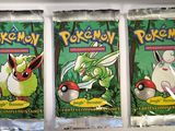 three packs of pokemon trading cards sitting on top of a shelf
