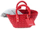 a red basket bag with a tag on the handle
