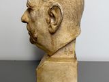 a close up of a sculpture of a man ' s head on a table