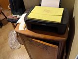 a printer sitting on top of a cabinet in a room