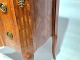 a small chest of drawers with a marble top