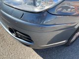 a close up of a car ' s headlight and front bumper
