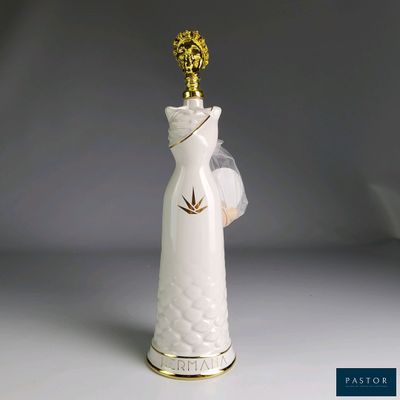 a white vase with a gold crown on top of it