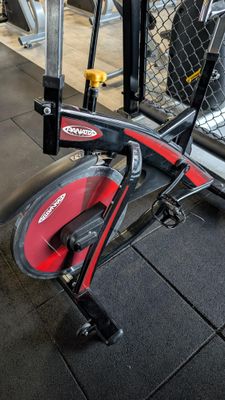 a red and black exercise bike in a gym
