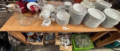 many plates and cups on a table in a store