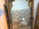 a mirror that is sitting on the floor next to a shelf