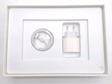 a white box with a charger and a cable in it