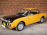 a yellow and black car parked in front of a brick wall