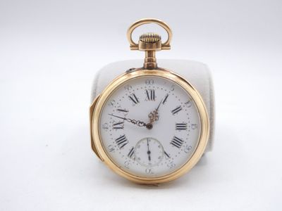 a gold pocket watch with roman numerals on it
