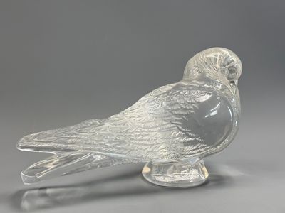 clear glass figurine of a bird sitting on a base