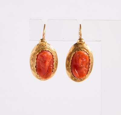 une photo d'une paire de boucles d'oreilles en or et en corail