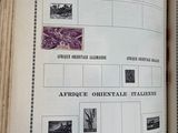 an open book with stamps on it on a table