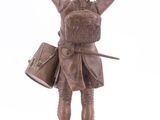 bronze statue of a man with a drum and a hat on a marble base