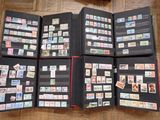 a lot of stamps in a folder on the floor
