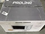 a box that is sitting on the floor with a microwave inside of it