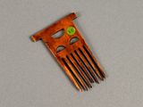 a small wooden comb with a green button on it