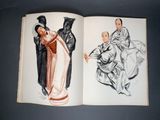 an open book with a drawing of a woman and a man in kimono robes