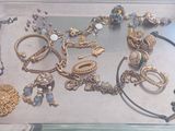 a tray with many different types of jewelry on it
