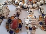 a picture of a necklace with many charms on it