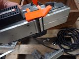 a person that is using a tool to cut a piece of wood