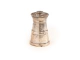 an antique silver pepper shaker on a white surface with a white background