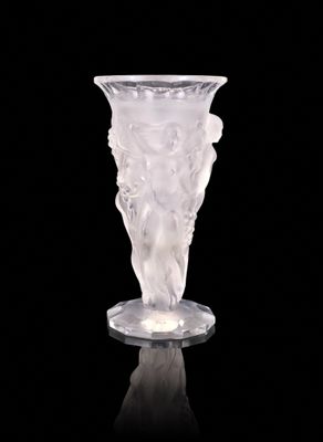 a glass vase that is sitting on a black surface