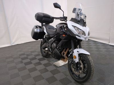 a motorcycle that is parked in a room with a checkered floor