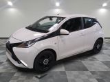 a picture of a white toyota yaris parked on a checkered floor