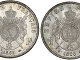 a silver coin with a crown on the front and a shield on the back