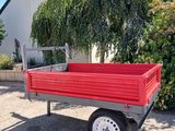 a red truck that is parked in front of a house