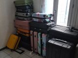 many suitcases stacked on top of each other in a room