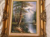 an image of a painting of a mountain scene in a gold frame