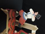 a small wooden toy of a man riding a skateboard