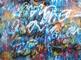 a painting of a bunch of graffiti on a wall near a fire hydrant