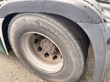 a close up of a truck tire on the road