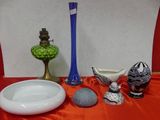 a table with a bowl, vase, and other items on it