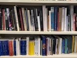 a book shelf with many books on it in a room