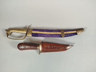 two different types of knives on a white surface