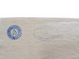 an envelope with a stamp on it sitting on top of a table