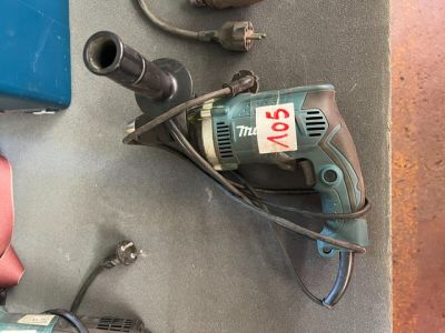 a drill and other tools that are on a table