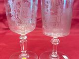 pair of etched glass goblets on a red table cloth