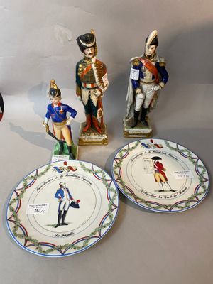 several figurines of soldiers are displayed on plates on a table