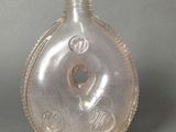 a clear glass bottle with a silver lid