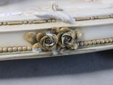 a white casket with three roses on it