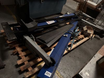 a pile of tools on a pallet in a warehouse