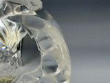 a glass vase with a dragon on it on a table